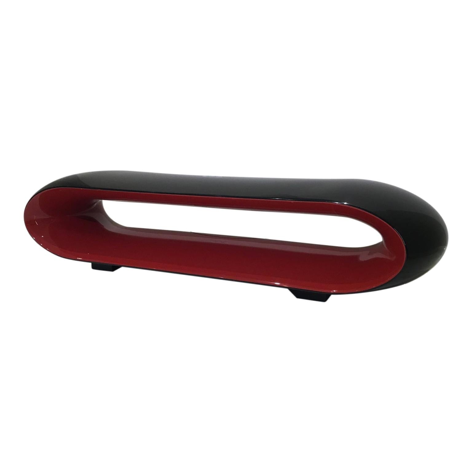 Black and red curved object on a white background