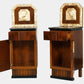 Pair of wooden cabinets with decorative tops featuring portraits on a white background