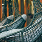 Hanging wicker chairs with cushions in a blurred indoor setting