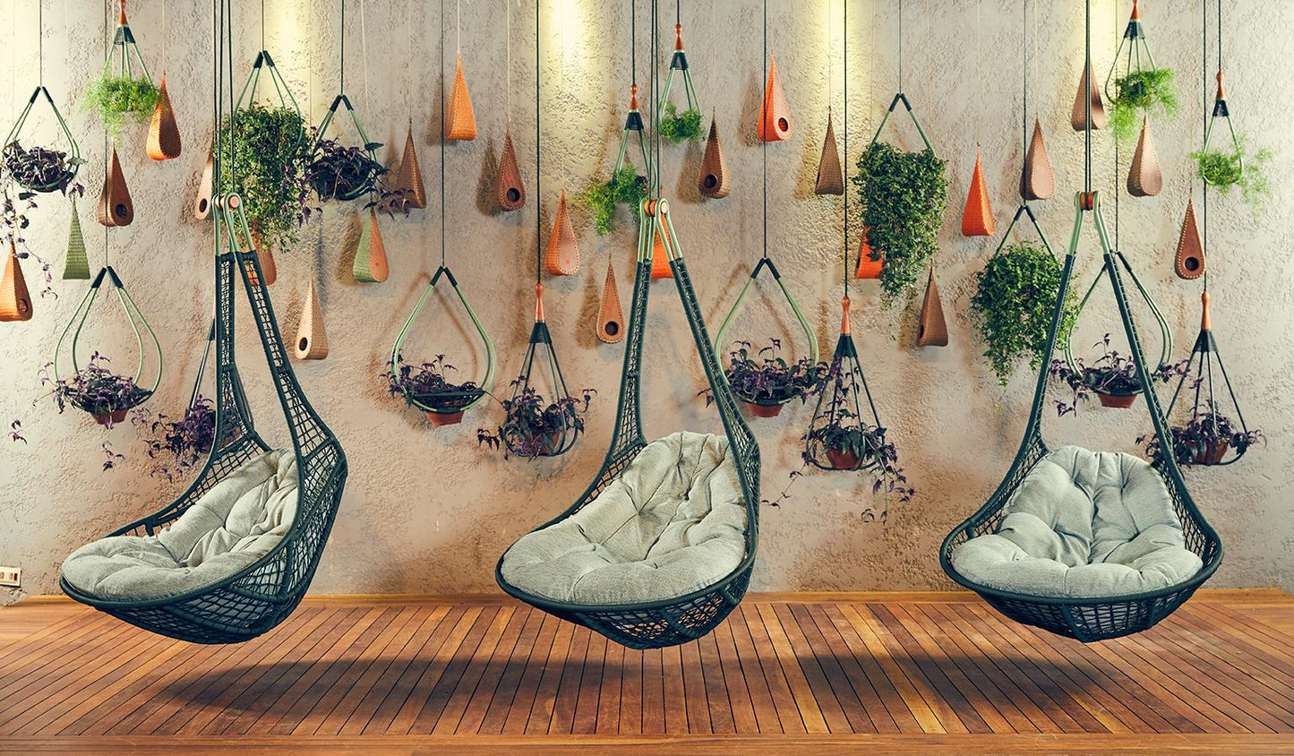 Hanging chairs with plants on a wall in a room with wooden flooring.