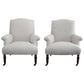 Two white armchairs with wooden legs on a white background