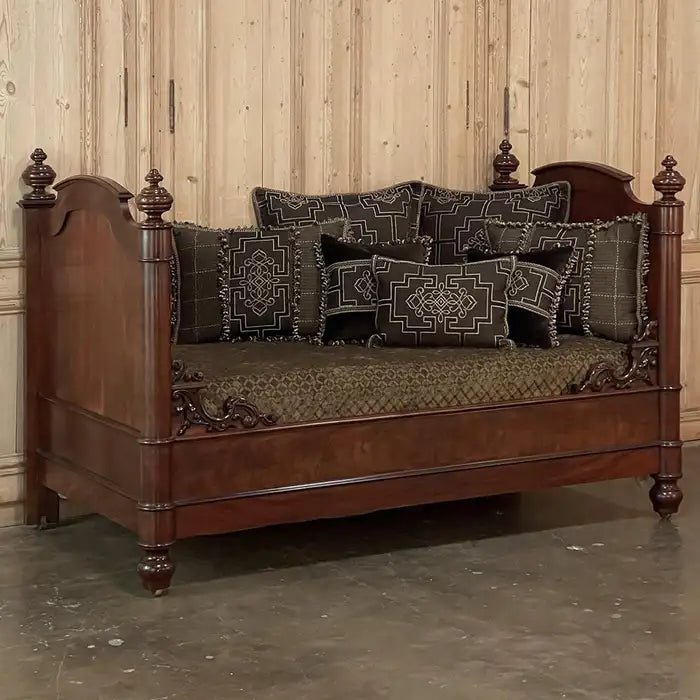 Vintage-style wooden sofa with decorative cushions against a wooden paneled wall.