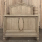 Vintage wooden bed with intricate carvings in a rustic setting