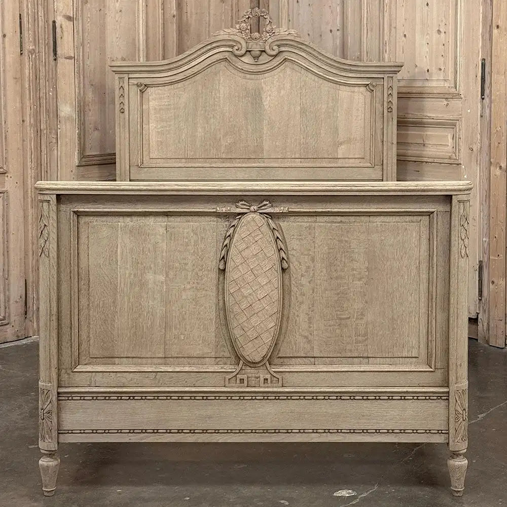 Vintage wooden bed with intricate carvings in a rustic setting