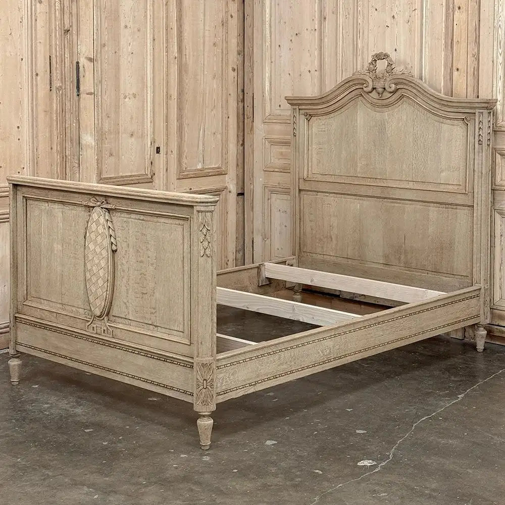 Wooden bed with intricate carvings in a room with wooden paneling.