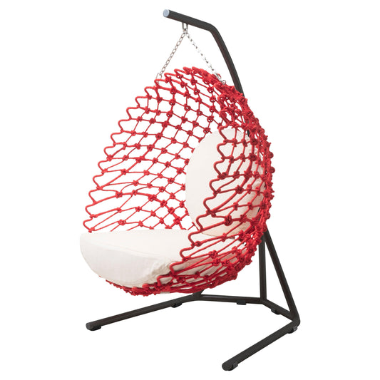 Red netted hanging chair with white cushion on a black stand against a white background