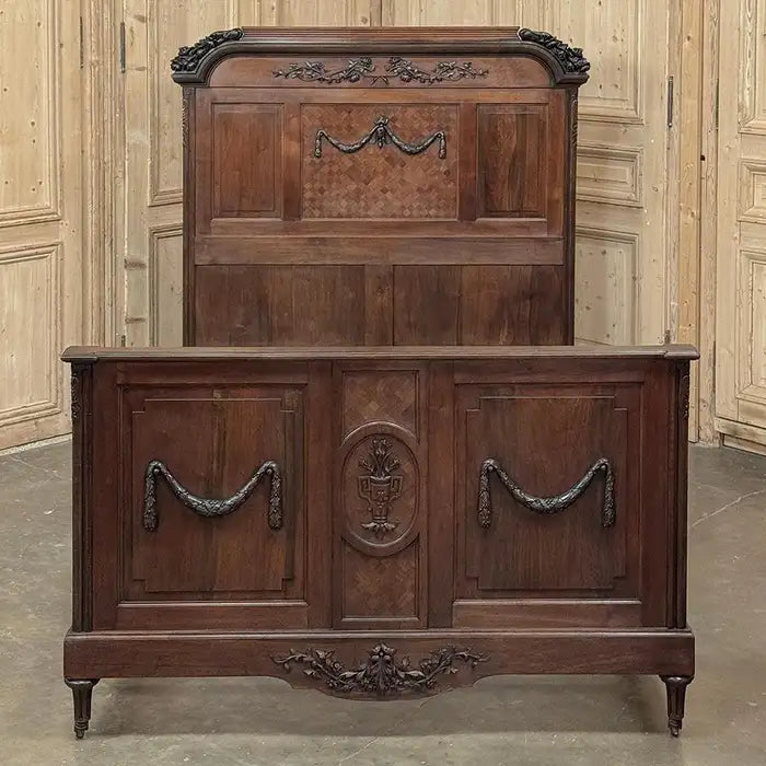 Vintage wooden dresser with intricate carvings in a room with paneled walls.