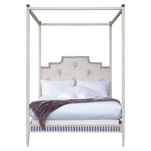 Four-poster bed with decorative headboard and white bedding on a white background