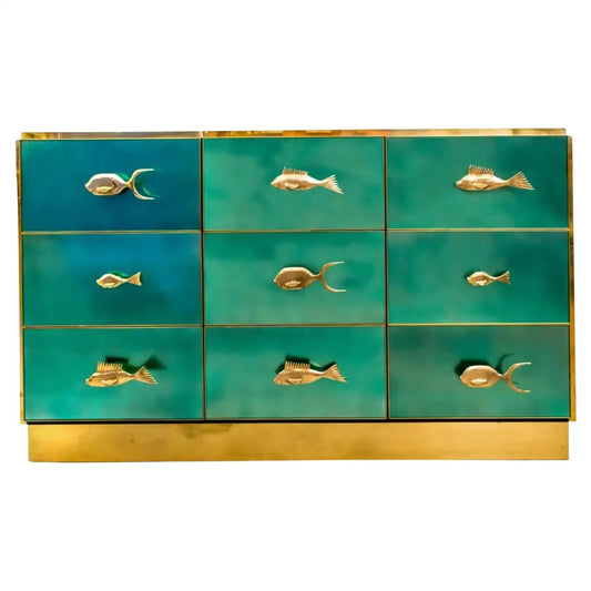 Teal dresser with gold fish-shaped handles on a white background