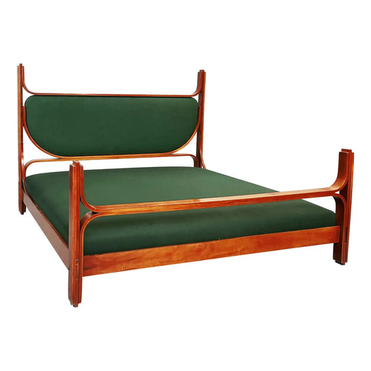 Wooden bed frame with green mattress on a white background