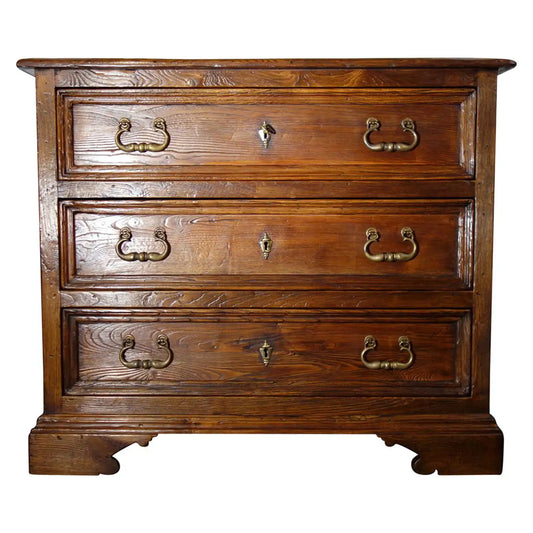Wooden dresser with three drawers and brass handles on a white background