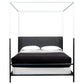 Black metal canopy bed with white bedding on a white background