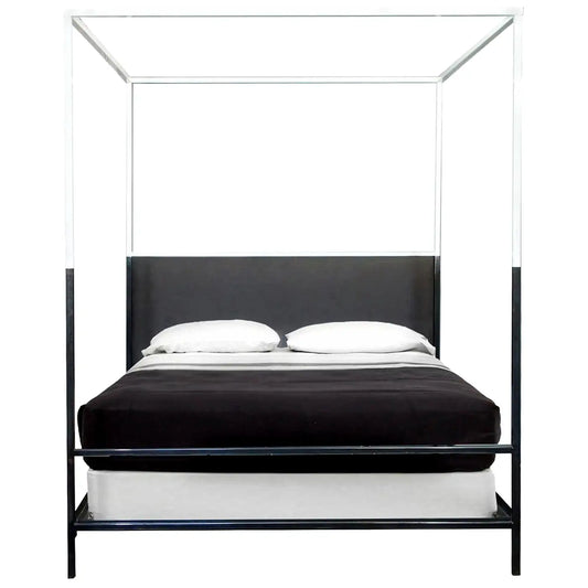 Black metal canopy bed with white bedding on a white background