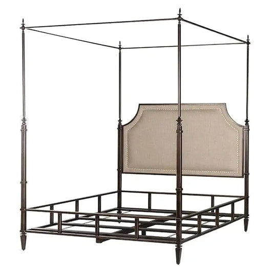 Canopy bed with metal frame and upholstered headboard on a white background