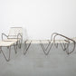 Modern lounge chair and table set on a gray floor with white background
