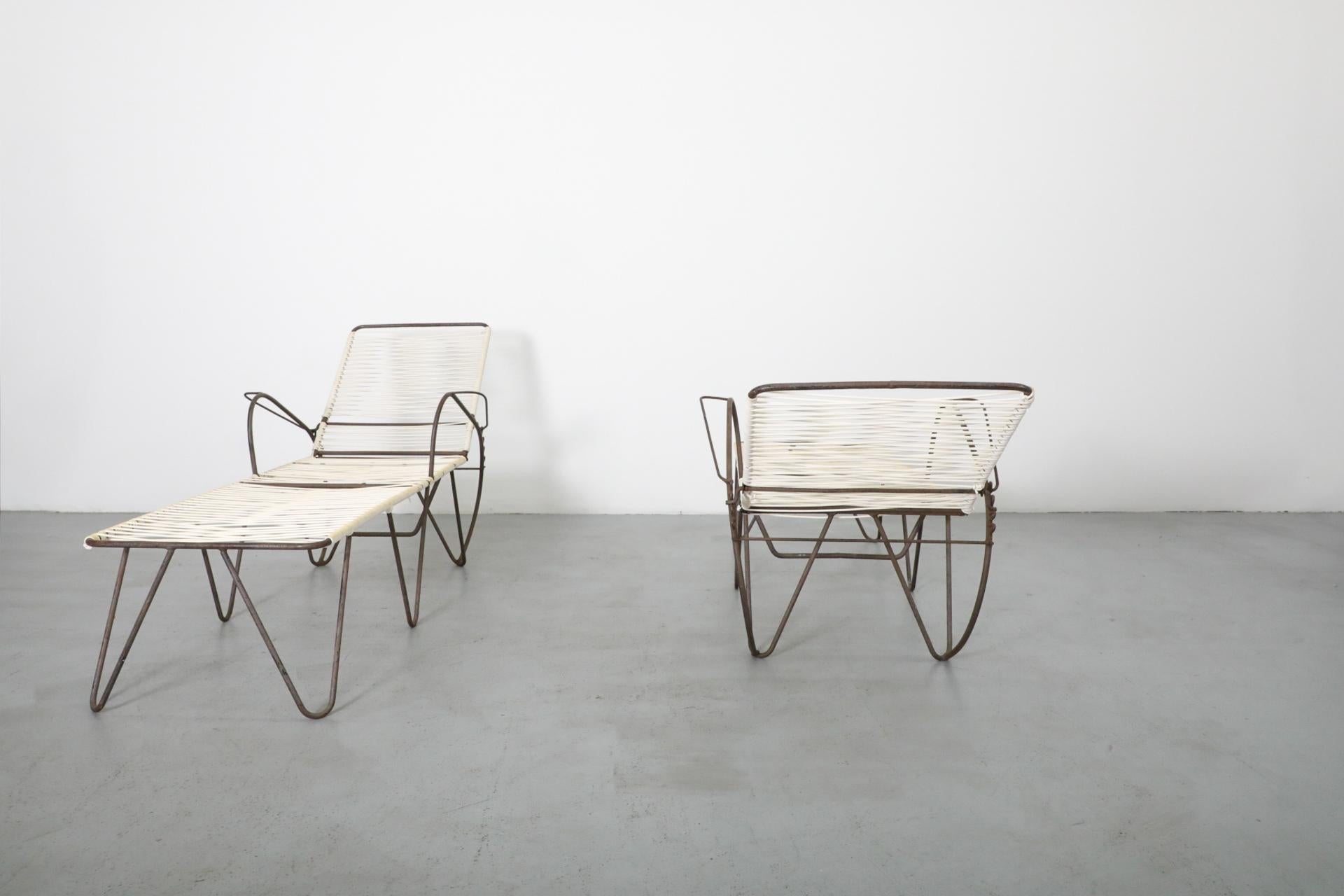 Modern outdoor furniture set with lounge chairs and table on a gray floor.