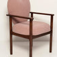 Pink armchair with wooden frame on a white background