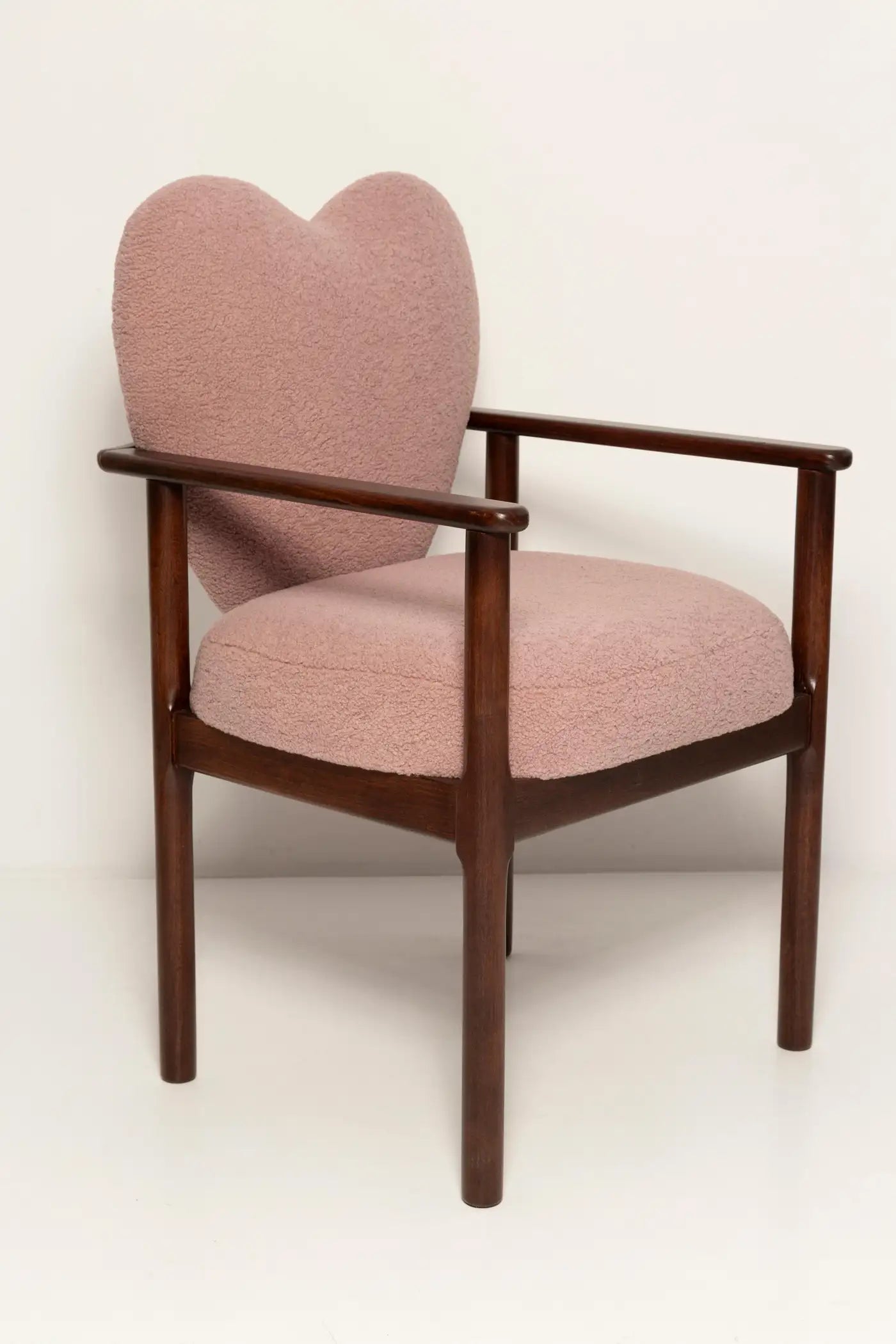 Pink armchair with wooden frame on a white background