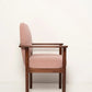 Chair with pink cushioned backrest and seat on a white background