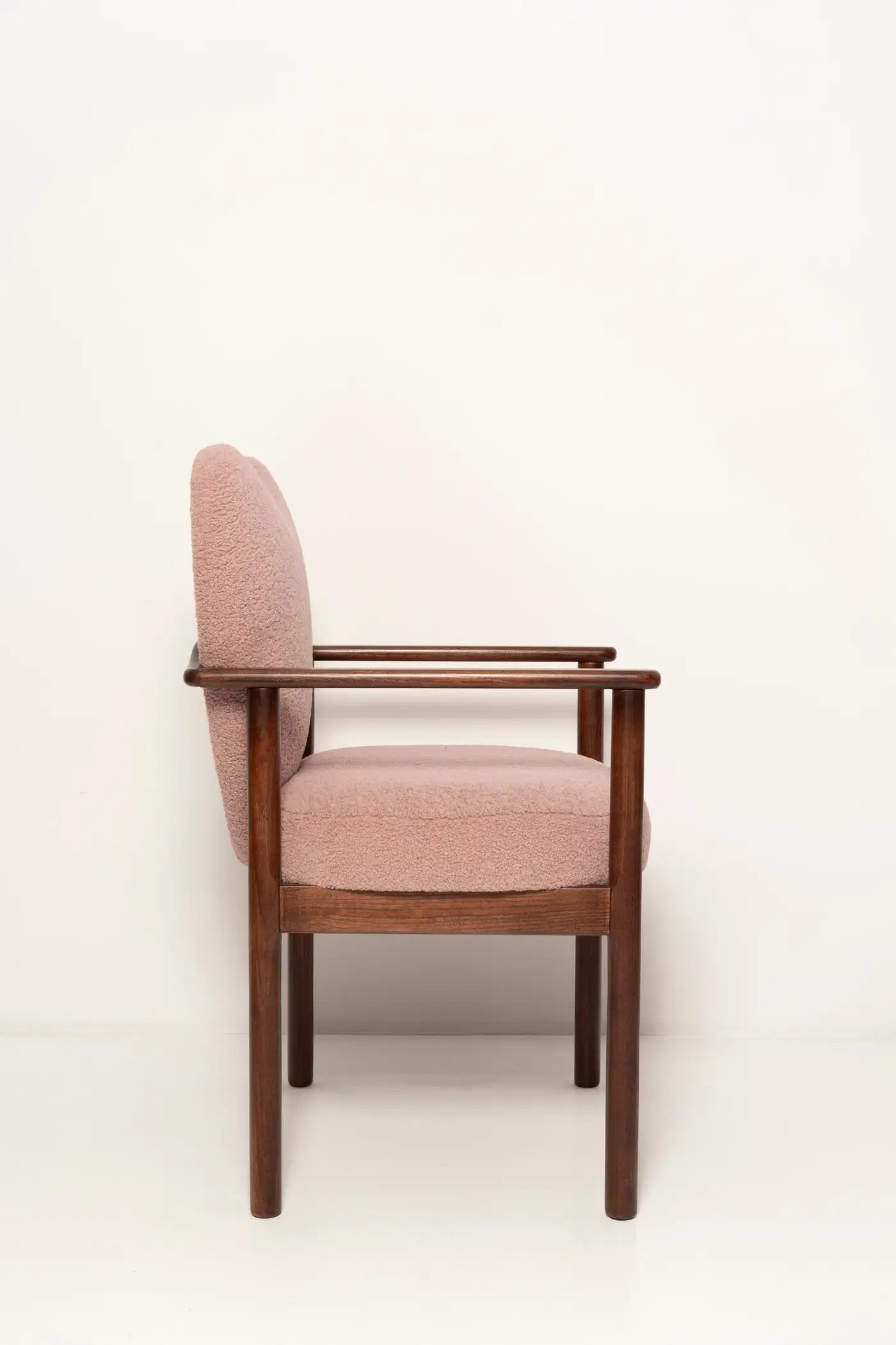 Chair with pink cushioned backrest and seat on a white background