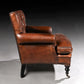 Brown leather armchair on a dark background