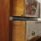 Close-up of a wooden drawer with brass handles on a piano.