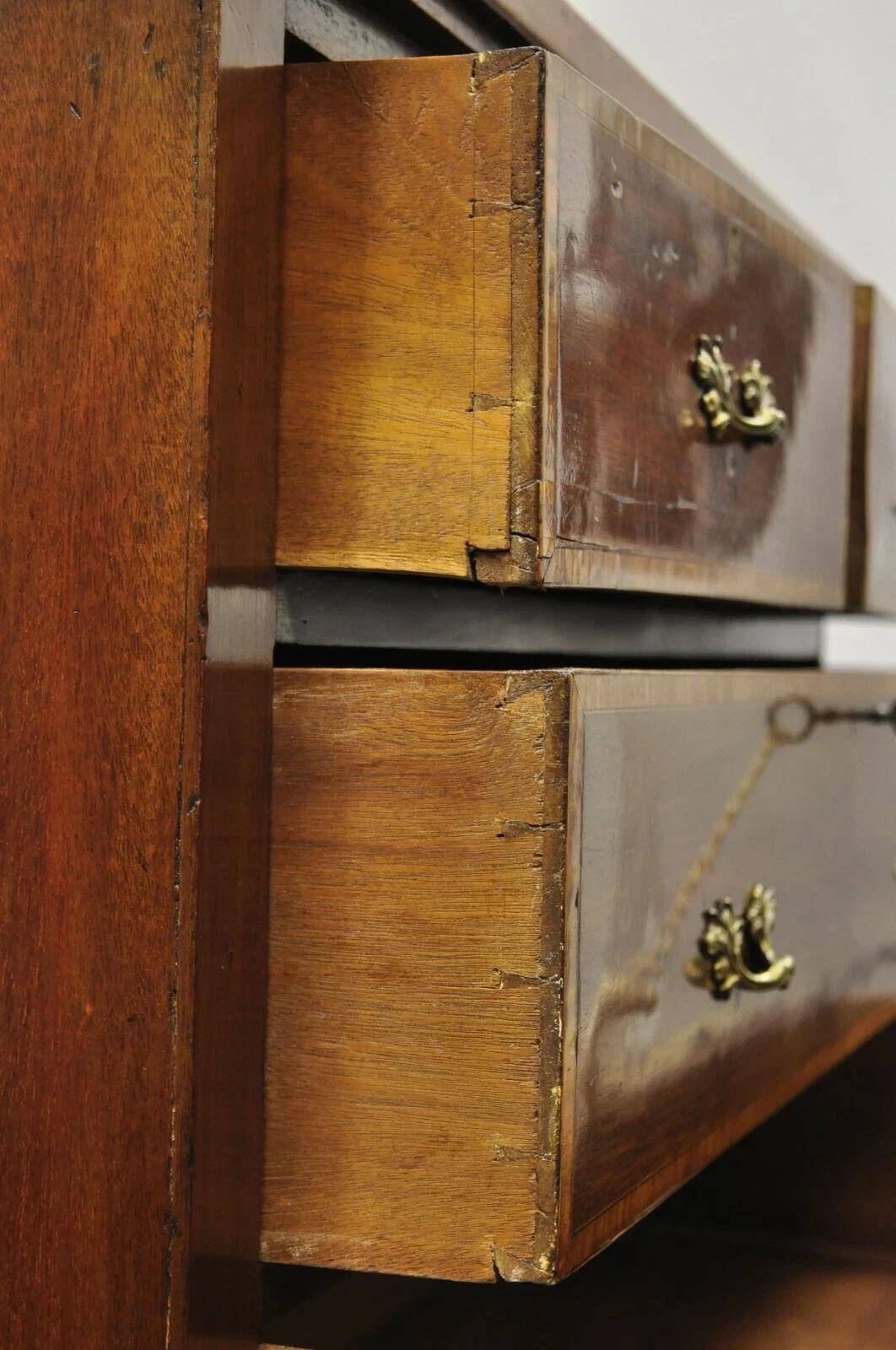 Close-up of a wooden drawer with brass handles on a piano.