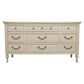 Beige dresser with multiple drawers and handles on a white background