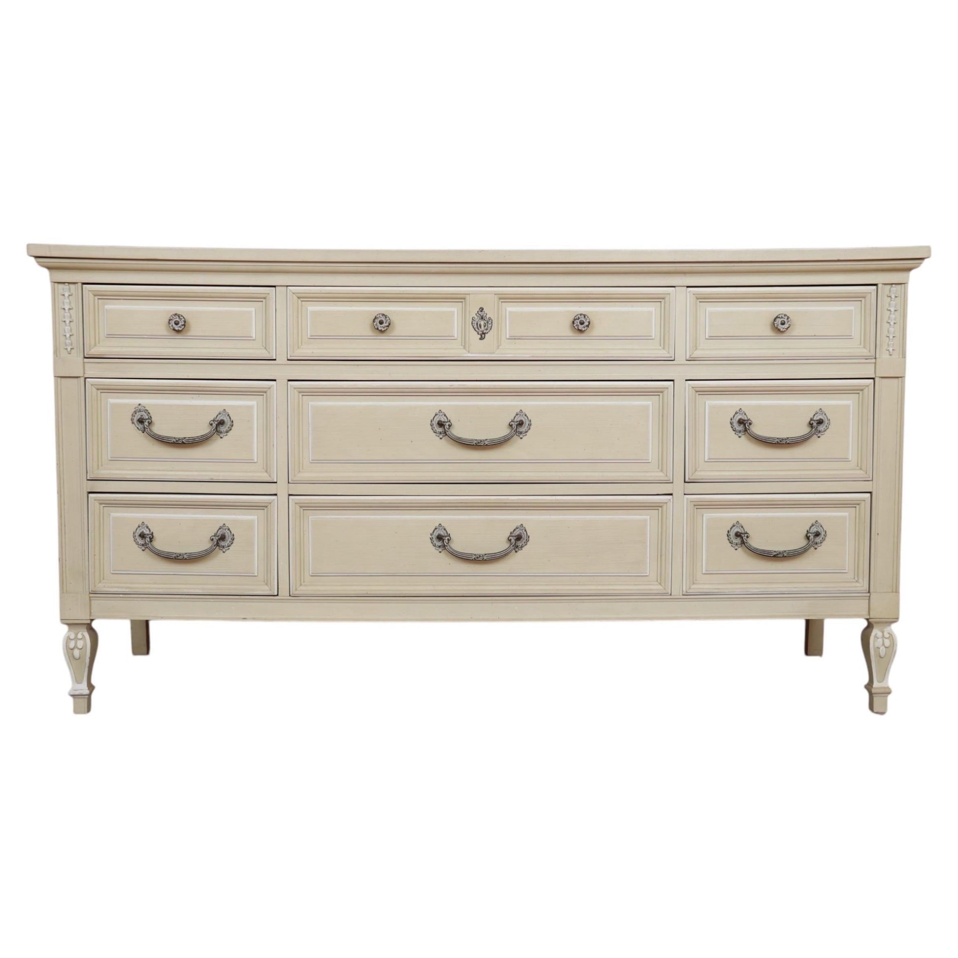 Beige dresser with multiple drawers and handles on a white background