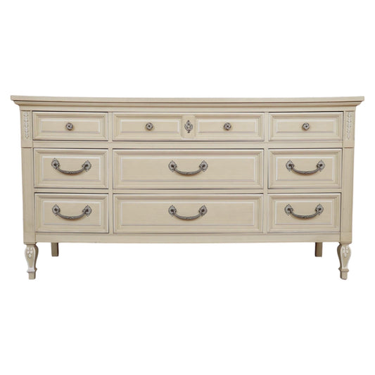 Beige dresser with multiple drawers and handles on a white background