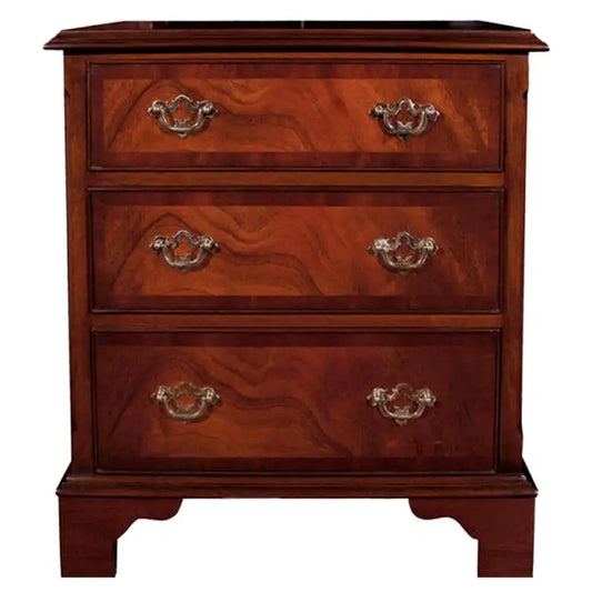 Wooden dresser with three drawers and brass handles on a white background