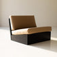 Modern chair with brown cushion on a plain background