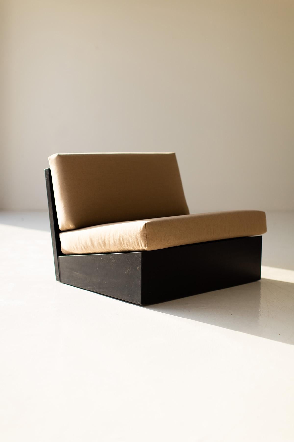 Modern chair with brown cushion on a plain background