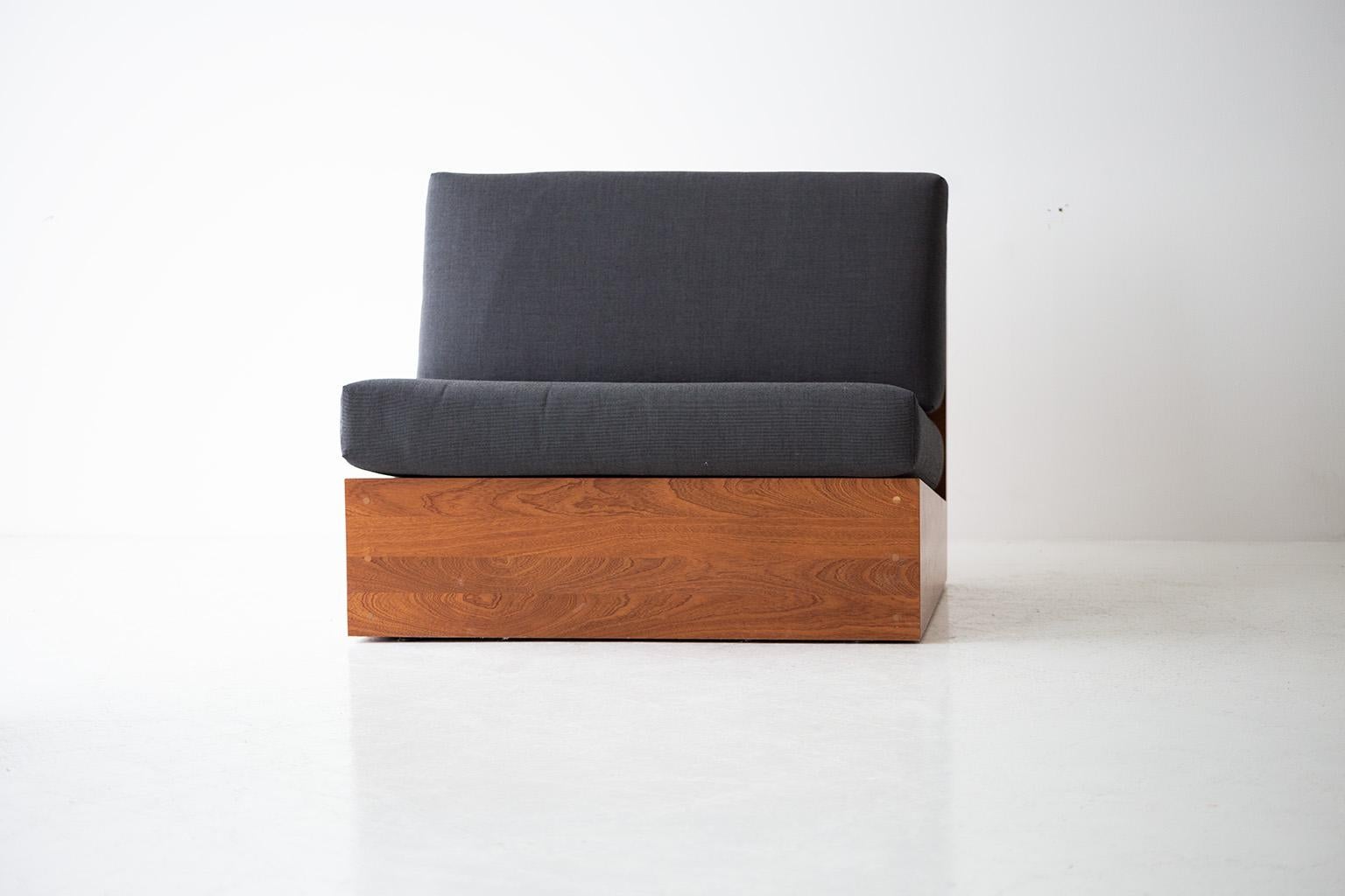 Sofa bed with wooden base and gray cushion on a white background