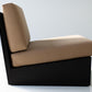 Modern chair with beige cushion and black frame on a white background