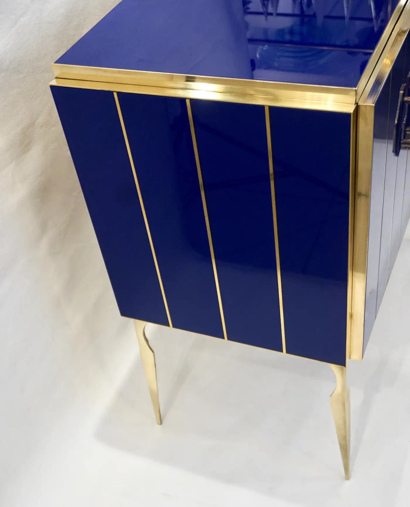 Blue cabinet with gold accents on a white background