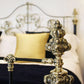 Decorative metal bed post with intricate design in a bedroom setting