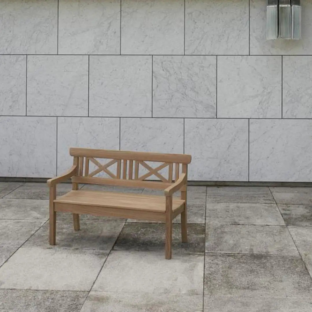 Wooden bench against a tiled wall