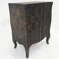 Decorative metal cabinet with intricate patterns on a white background