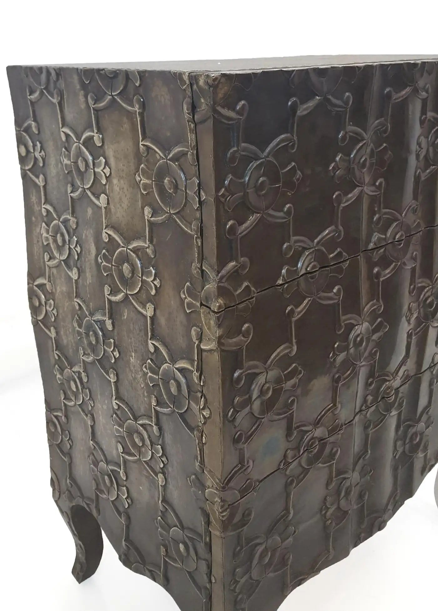 Decorative metal box with intricate patterns on a white background