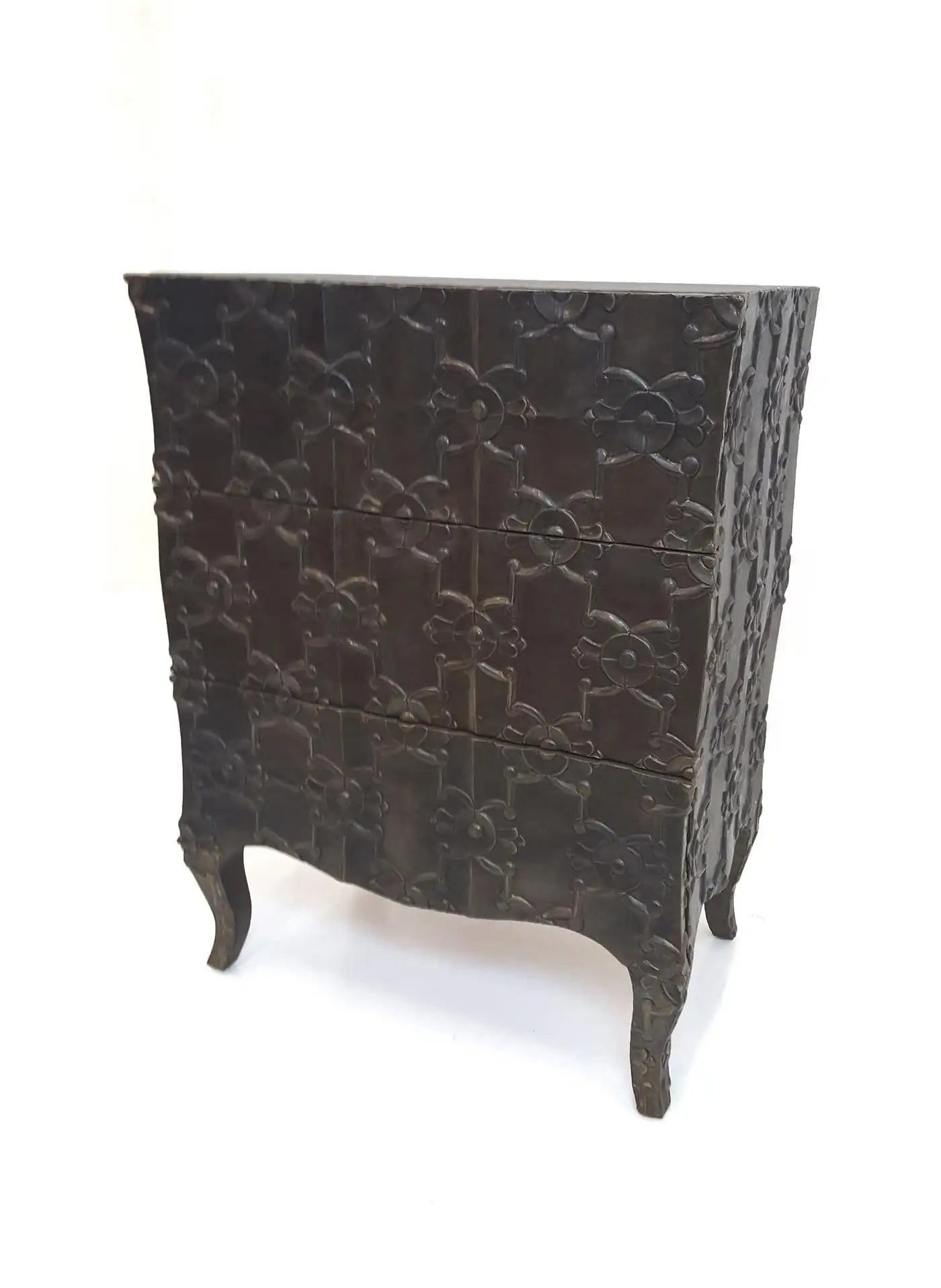 Decorative chest of drawers with intricate carvings on a white background