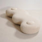White textured cushion on a light gray background