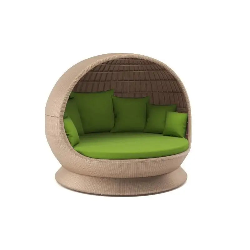Wicker egg-shaped chair with green cushions on a white background