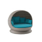 Round wicker chair with teal cushions on a white background