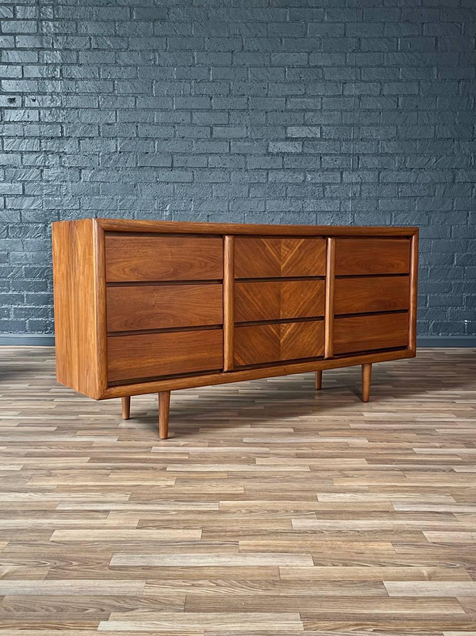 Wooden dresser against a brick wall