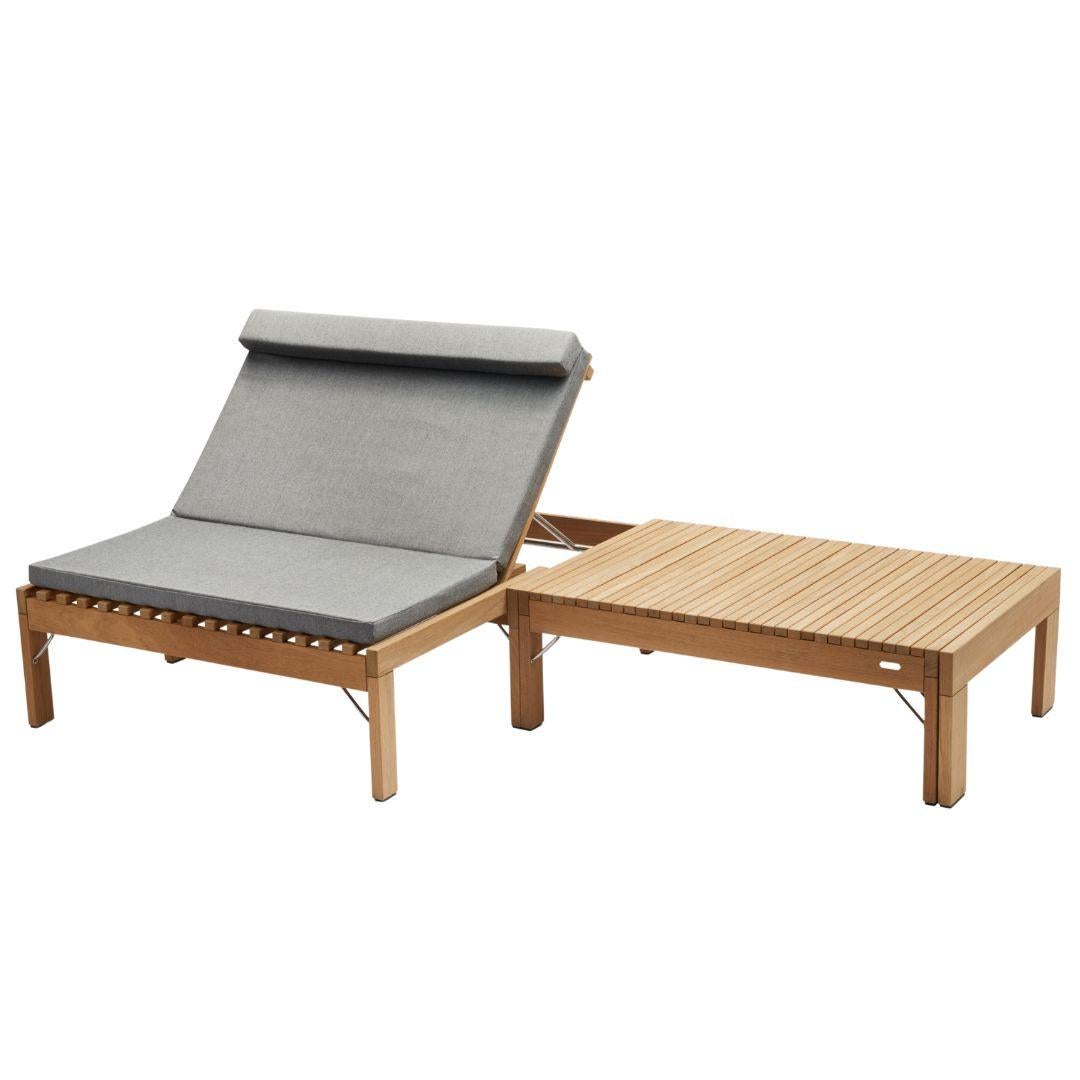 Wooden outdoor lounge chair with gray cushion on a white background
