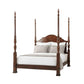 Wooden four-poster bed with white bedding on a white background