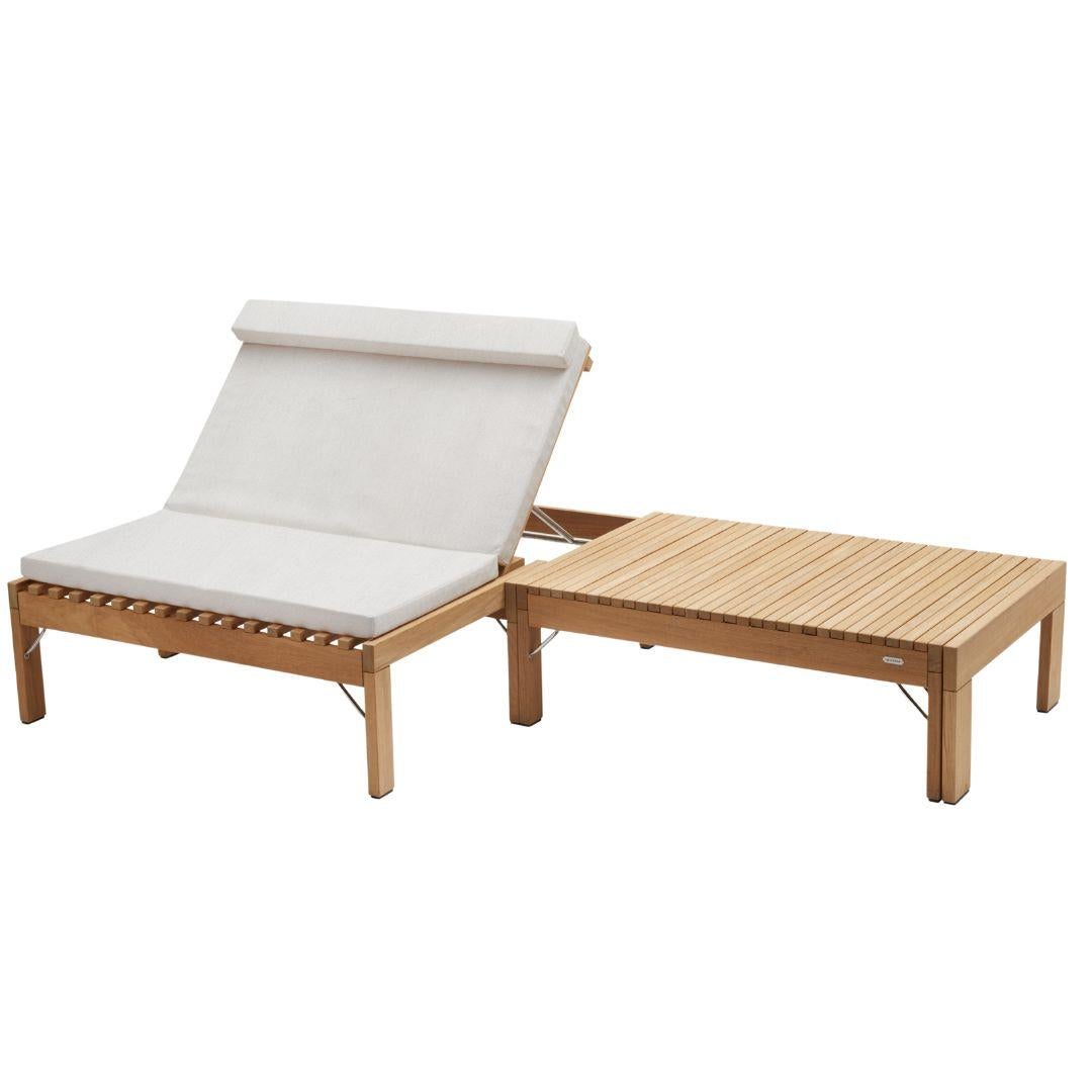 Wooden outdoor lounge chair with white cushion on a white background