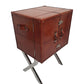 Brown leather suitcase on a metal stand against a white background