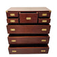Stack of wooden boxes with brass handles on a white background